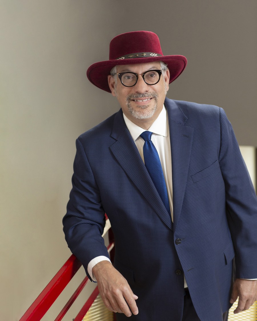 Michael Einbinder-Schatz wearing a red hat